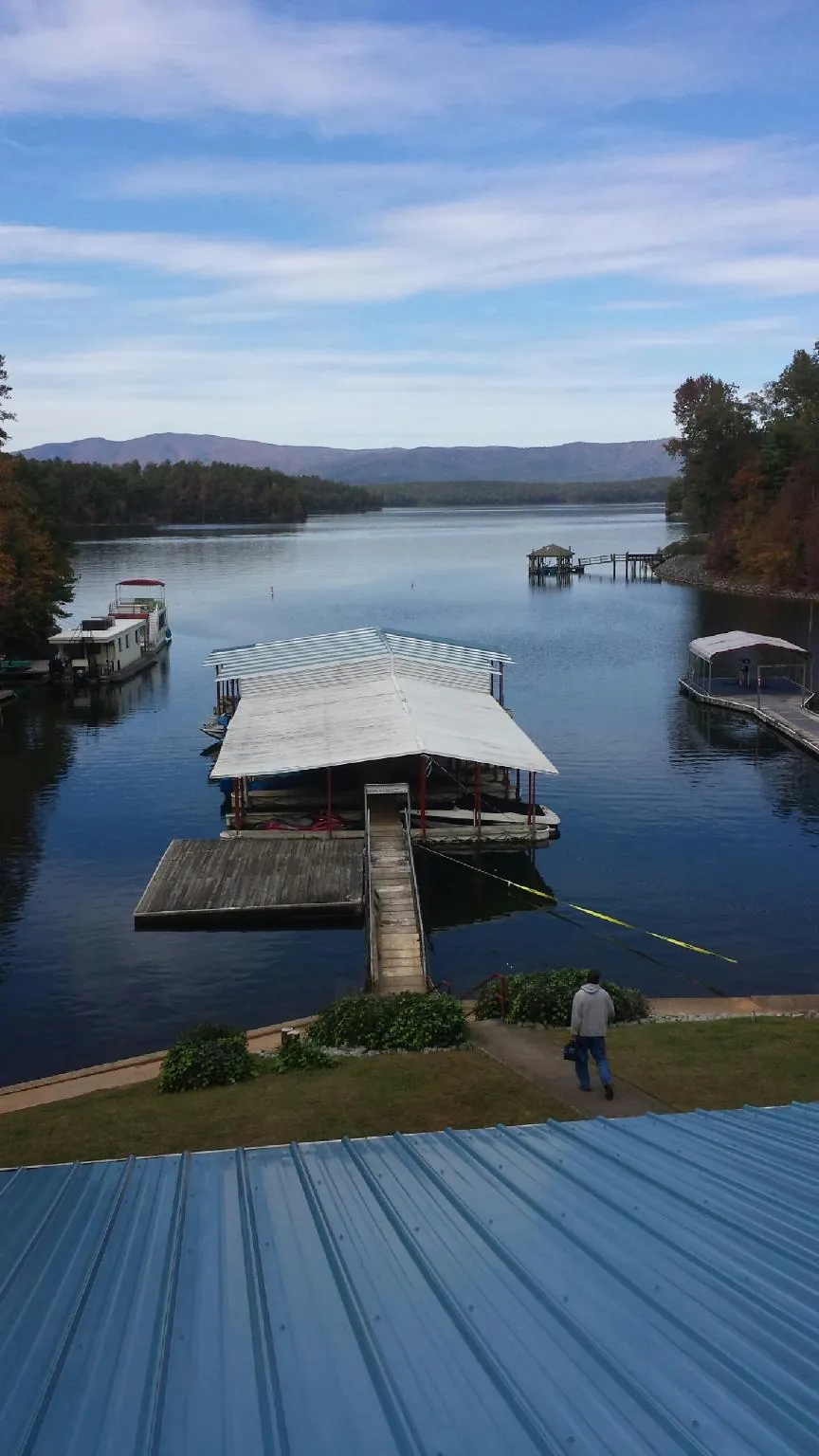 View across a lake from a newly installed blue metal roof in Winter Garden